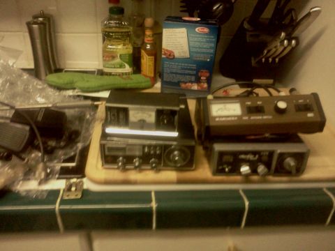 1968 Ford Bronco - A collection of CB radios and a microphone are displayed on a countertop.
