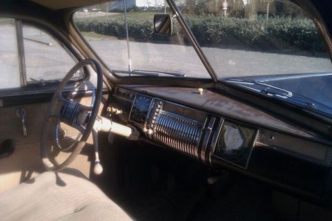 1991 Ford Crown Victoria - The interior of a classic car showcases a detailed dashboard with a prominent steering wheel and vintage gauges.