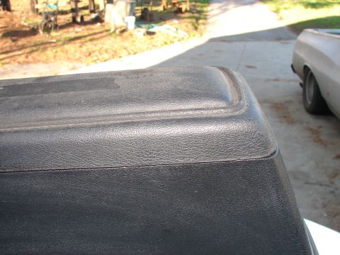 1973 Ford Ranchero - Close-up of black textured plastic trim on a vehicle, with a second vehicle partially visible in the background.