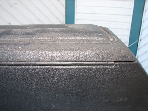 1973 Ford Ranchero - Close-up of a truck bed cover hinge shows textured plastic and metal components.