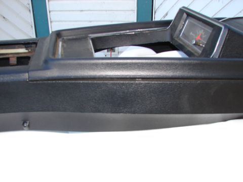 1973 Ford Ranchero - Dashboard trim piece with an inset clock. The clock hands are red and black.