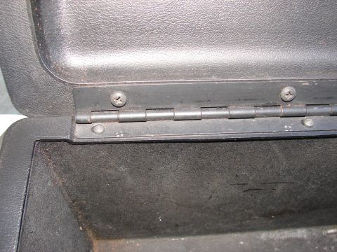 1973 Ford Ranchero - Close-up view of a vehicle's center console hinge mechanism.