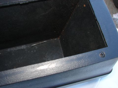 1973 Ford Ranchero - Black plastic interior car part, possibly a storage compartment, with a visible screw.