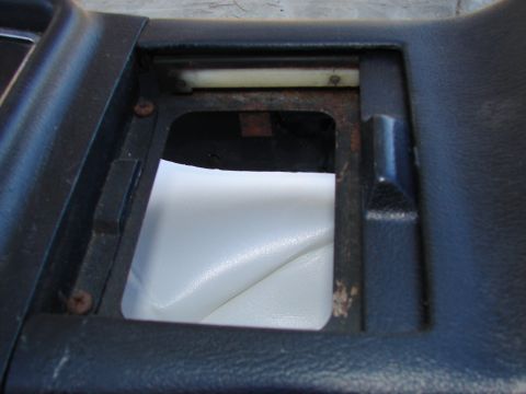 1973 Ford Ranchero - Close-up view of an interior automotive part, showing a vacant space with white upholstery beneath.