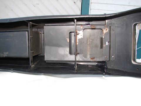 1973 Ford Ranchero - Close-up view of a dark-colored vehicle component, showing internal metal structures and signs of wear.