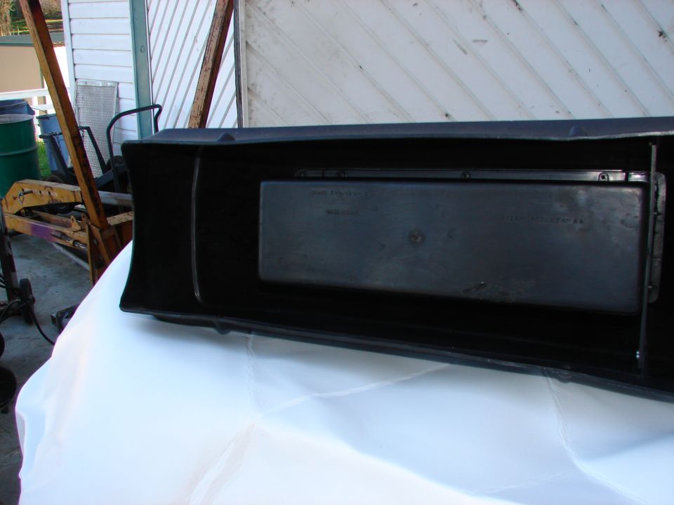 Black plastic part with faint text inside