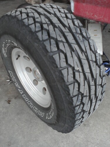 1989 Ford Bronco - Tire and wheel detail, with 'SKY MOUNTAIN' visible on the sidewall.