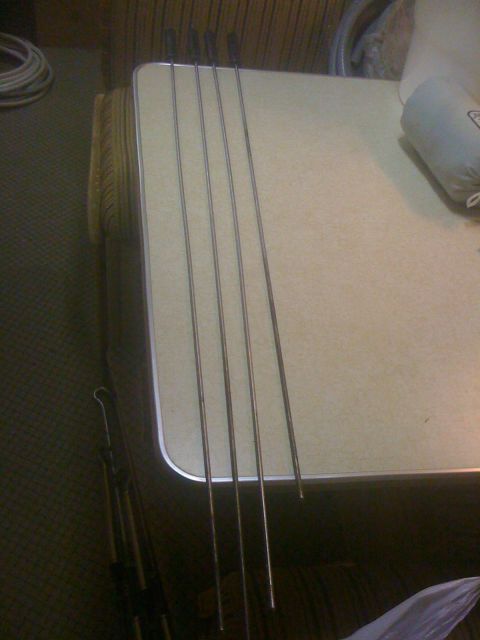 1968 Ford Mustang - Five metal rods with black handles are placed on a table.