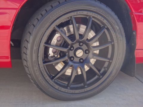 1993 Ford Taurus - Close-up of a black Team Dynamics Motorsport wheel and Good Year tire on a red vehicle.