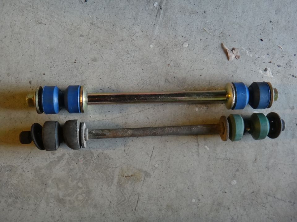 New blue sway bar end link next to old rusty green one