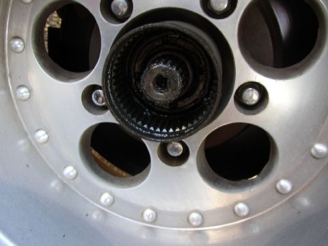 1989 Ford Bronco - A close-up view of a greased wheel hub with visible gears.