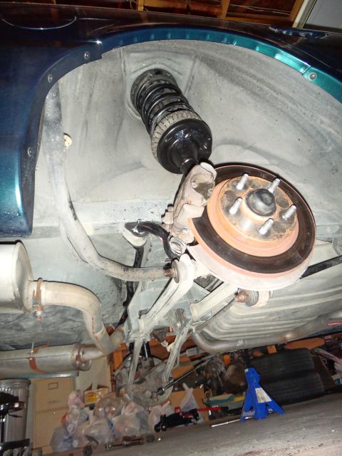 1993 Ford Taurus - The rear suspension and brake assembly of a 1993 Ford Taurus is visible in this underside view.