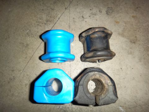 1993 Ford Taurus - Comparison of new blue and old black suspension bushings, suggesting a part replacement.