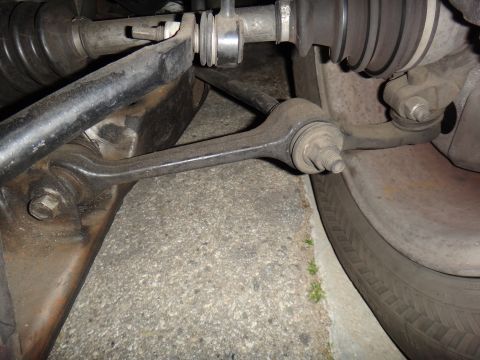 1993 Ford Taurus - Close-up view of a vehicle's suspension system and tire.