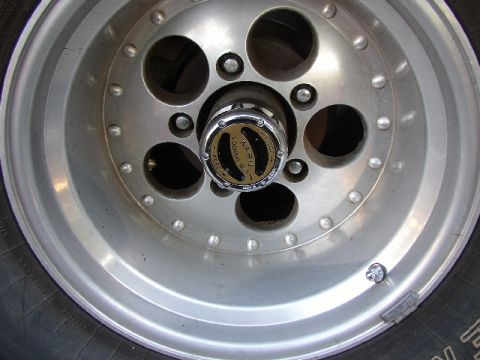 1989 Ford Bronco - A close-up view of a vehicle's wheel and a Warn locking hub is visible.
