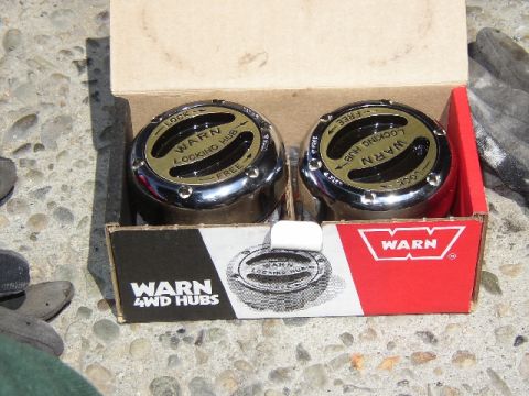 1989 Ford Bronco - A pair of Warn 4WD locking hubs are presented in their original packaging.