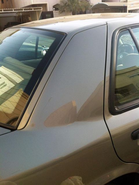 2001 Mercury Grand Marquis - Side view of a 2001 Mercury Grand Marquis, focusing on the rear quarter panel and window.