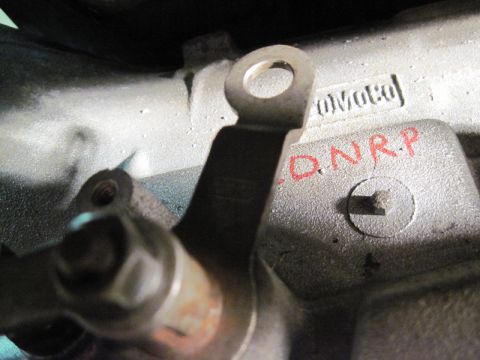 1969 Ford Fairlane - A metal engine component displays stamped and handwritten markings, with no clear indication of vehicle model or year.