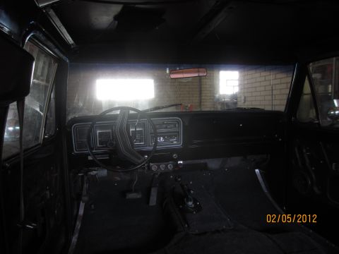 1979 Ford Bronco - The interior of a 1979 Ford Bronco, its dashboard, steering wheel, and floor shifter.