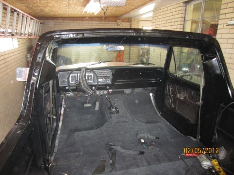 1979 Ford Bronco - Interior view of a 1979 Ford Bronco, with dashboard and floor visible.