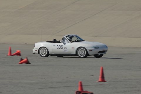 1991 Mazda Miata - White 1991 Mazda Miata navigates a race track, marked with number 306.
