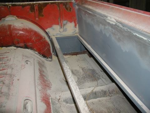 1960 Ford Ranchero - Interior of a truck bed undergoing restoration, showing primer and body filler work.