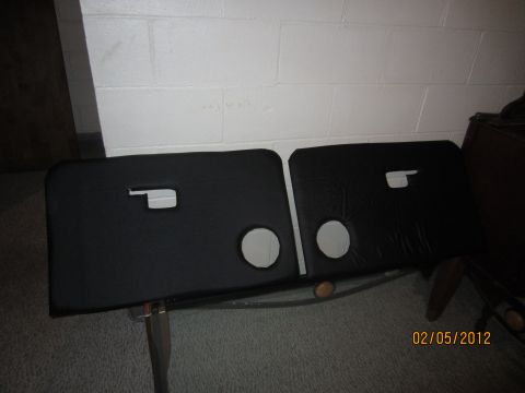 1979 Ford Bronco - Pair of black door panels with circular speaker cutouts and handle openings.