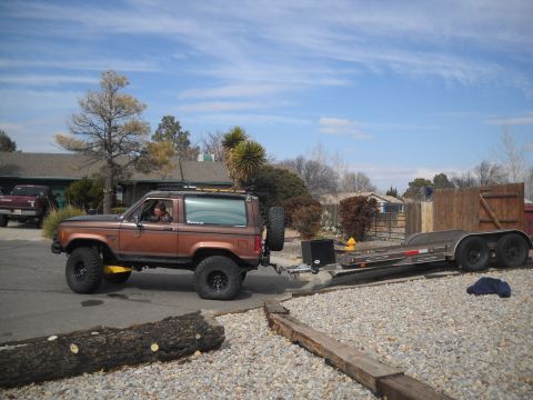 1992 Ford Explorer - A brown Ford Bronco II is seen towing a trailer on a sunny day.