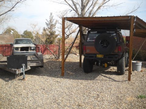 1992 Ford Explorer - This brown SUV, possibly a 1992 model, is parked under a shelter with a spare tire mounted on its rear.