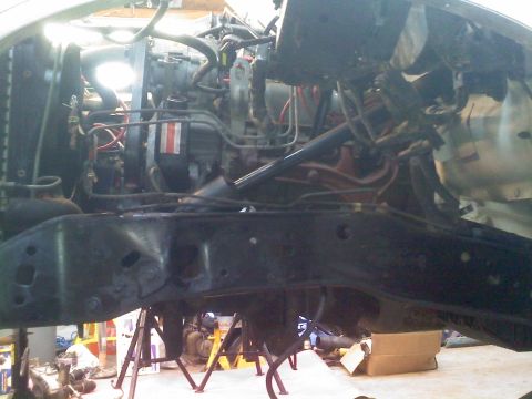 1996 Ford Bronco - The engine and chassis of a vehicle are visible, undergoing maintenance or repair work.
