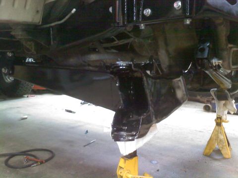 1996 Ford Bronco - The vehicle's undercarriage and suspension system are supported by jack stands for maintenance.