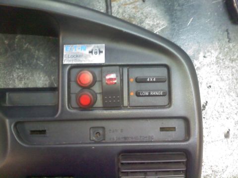 1996 Ford Bronco - Close-up of a vehicle's dashboard, showing various control buttons and labels.