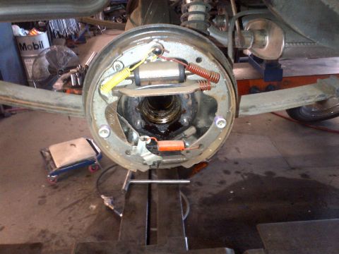 1965 Ford Mustang - The rear brake drum assembly is shown with its internal components exposed for maintenance or inspection.