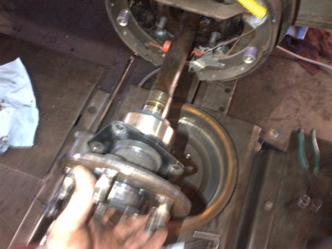 1965 Ford Mustang - Close-up of a vehicle's brake assembly, showing the drum, hub, and brake shoes.