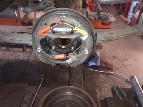 1965 Ford Mustang - This is a close-up view of a vehicle's brake drum assembly, showing the brake shoes and springs.