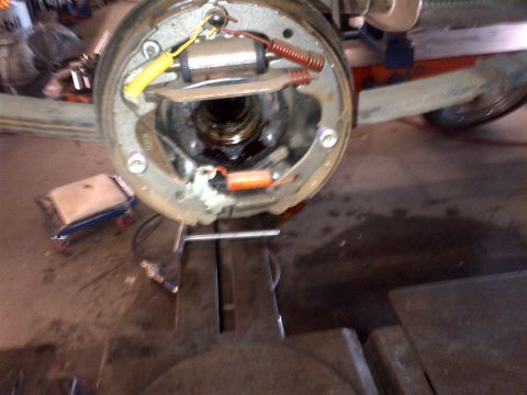1965 Ford Mustang - Close-up of a car's brake drum assembly, showing internal components.