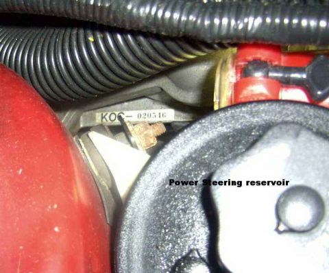1997 Ford Taurus - Engine component detail with part number and power steering reservoir visible.