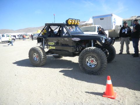 1997 Ford Ranger - A custom-built off-road buggy with a roll cage and large tires sits on a sandy surface.
