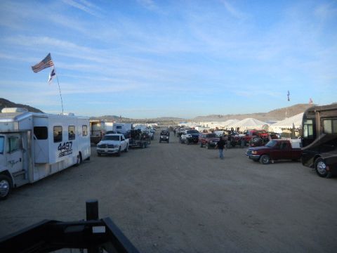 1997 Ford Ranger - A wide view of a desert event with various vehicles, RVs, and tents set up under a partly cloudy sky.
