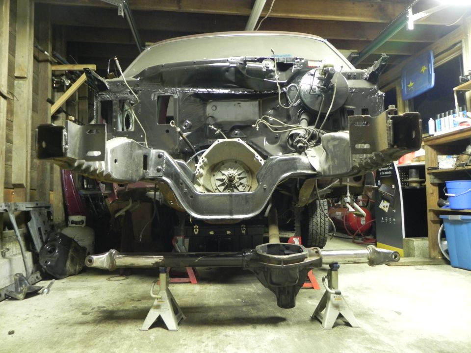 1993 Ford Bronco chassis on jack stands, front end removed, transmission visible