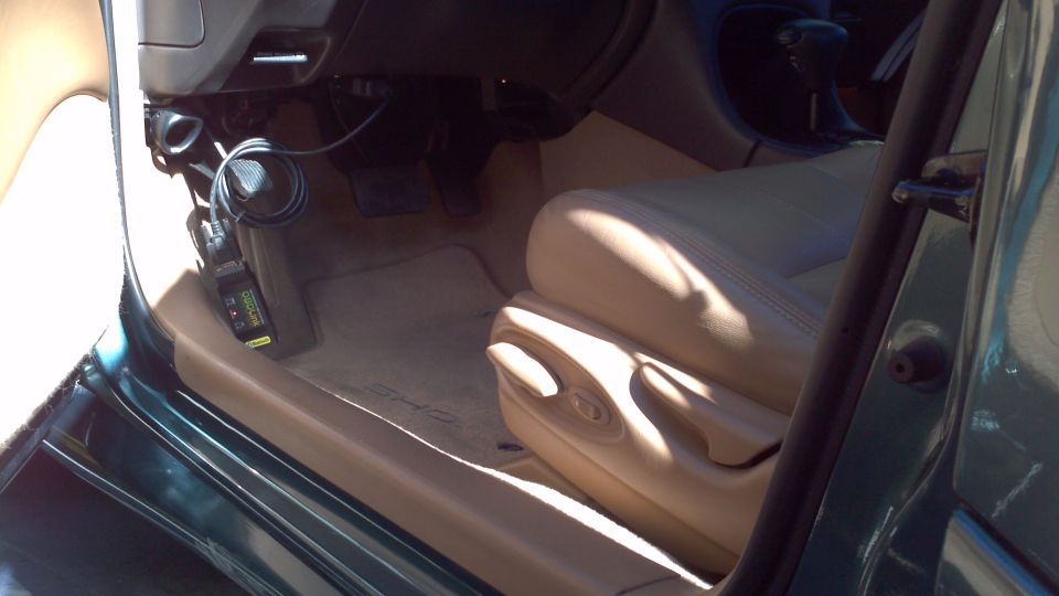 Interior of a 1996 Ford Taurus showing tan leather seats and dashboard