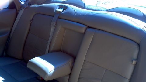 1996 Ford Taurus - The interior of a car shows the rear seats and a fold-down armrest.