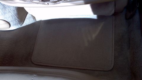 1996 Ford Taurus - Close-up view of the interior floor mat and carpet in a vehicle.