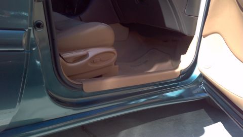 1996 Ford Taurus - The interior of a 1996 Ford Taurus shows the driver's side door jamb and tan upholstery.