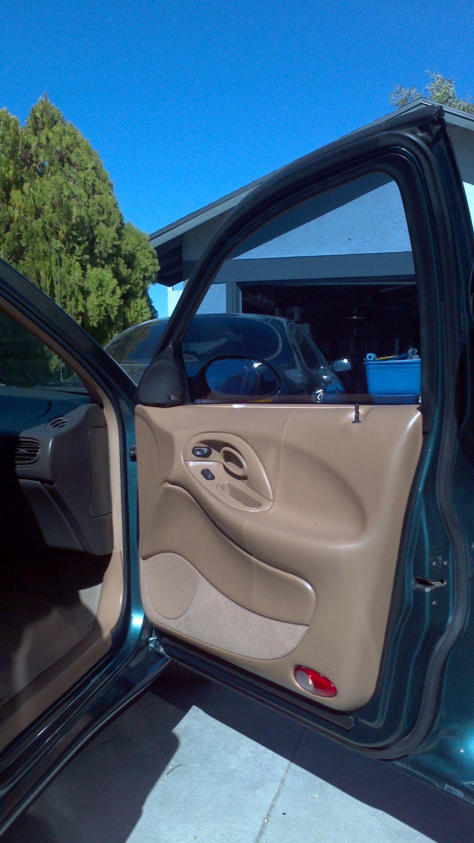 1996 Ford Taurus interior door panel with tan trim and power window controls