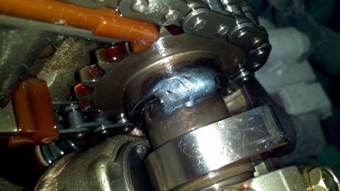 1996 Ford Taurus - Close-up of a welded camshaft, showing mechanical components and oil residue.