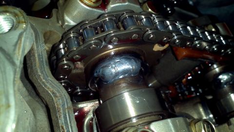 1996 Ford Taurus - Close-up view of a camshaft timing chain and sprocket assembly, showing a weld repair on the sprocket.