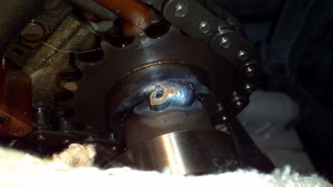 1996 Ford Taurus - This image shows a close-up view of an engine's timing chain and sprocket assembly, highlighting a weld repair.