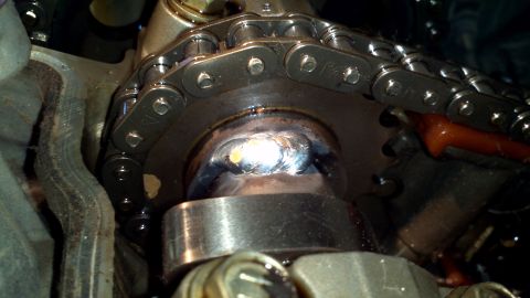 1996 Ford Taurus - Close-up of an engine's timing chain and sprocket assembly, showing a weld repair on the sprocket hub.