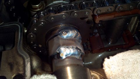 1996 Ford Taurus - Close-up of a welded engine component and timing chain, with a Supermotors.net watermark.